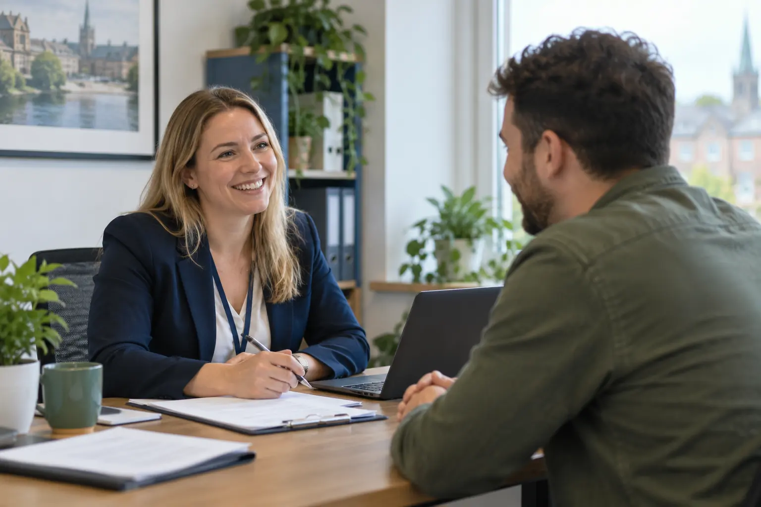 A recruitment consultant talking with an applicant across a desk